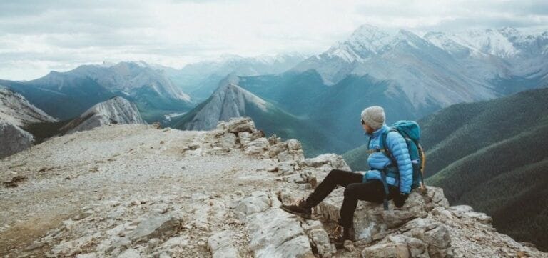 Men sitting on top of a mountain