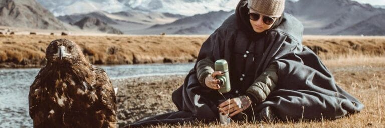 Women making coffee while camping in the mountains